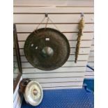 A large gong 57cm, on other smaller gong on oak plaque, a set of graduated cow bells and a drum