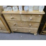 A Victorian stripped pine chest having 2 short and 2 long drawers and a dressing mirror