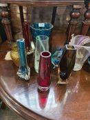 A quantity of coloured glass vases and similar
