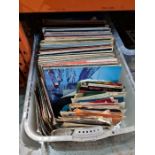 A box of vinyl LPs and other 7" singles