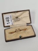 Antique 15ct yellow gold bar brooch with applied crown and seed pearl decoration, marked 15ct in bro