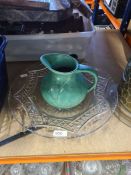 A brass stick stand, a large glass bowl and a jug
