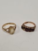 Two 9ct yellow gold dress rings, one a garnet example, one stone missing the other set oval faceted