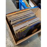 A carton of vinyl LP records including 70s and 80s, and a carton of 7" singles