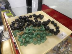 Strand of Jade beads, with silver clasp and a strand of possible Jet beads