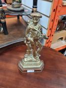 A brass door stop in form of Sailor with writing "Britains Pride"