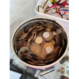 A tin of mainly copper coinage and a tub of mainly copper coinage and a tub of military badges and s