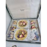 An Aynsley boxed coffee set containing 6 cups and saucers decorated fruit