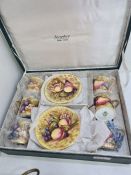 An Aynsley boxed coffee set containing 6 cups and saucers decorated fruit