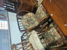 A pair of Ercol style stickback armchairs with loose cushions, a mahogany blanket box and a single k