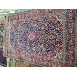 An old Persian rug having all over floral design with central diamond motif, 207 x 138cm