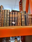 A shelf of leather bound antiquarian books and others, including three volumes of Colman's prose wor