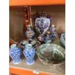 A mixed lot of Chinese and Japanese items to include Imari ginger jars and a pair of blue and white