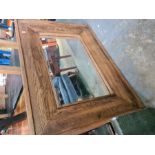 A modern oak framed mirror and a school desk