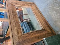 A modern oak framed mirror and a school desk