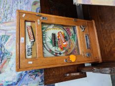 A vintage penny slot machine with glazed door decoration fruit (Win a Spangles, by Whales of Redcar)
