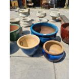 A large blue glazed garden pot and two other garden pots