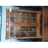 A reproduction Oak dresser, having carved decoration with rack back and a display cabinet having two