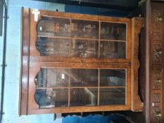 A reproduction Oak dresser, having carved decoration with rack back and a display cabinet having two