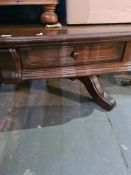 A reproduction oak coffee table having 2 drawers on splay legs