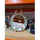 A Sitzendorf style easel mirror decorated two cherubs and a vintage Bakerlite telephone