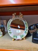 A Sitzendorf style easel mirror decorated two cherubs and a vintage Bakerlite telephone