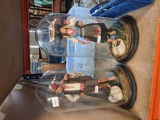 Two vintage plaster Mediterrandan figures, in glass domes