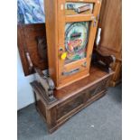 A carved oak monks bench on lion supports 106cm