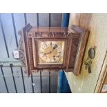 A wooden cased mantle clock with brass and painted dial, Roman numerals
