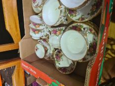 A selection of Royal Albert Country Rose pattern cups, saucers, cake stand, etc