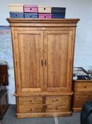 A reproduction Oak wardrobe having 2 doors with lower drawers and a matching chest of drawers