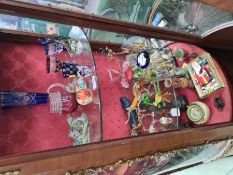 Two shelves of assorted glass including animals