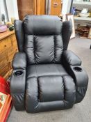 A modern faux leather recliner by Ebern designs having massage functions