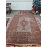 A modern Persian style rug having central motif in a cream field, 293 x 199cm