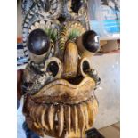 An old African tribal mask and other more modern masks and tribal items