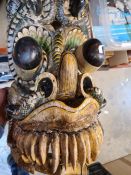 An old African tribal mask and other more modern masks and tribal items