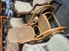 A modern bentwood rocking armchair having cane seat and back