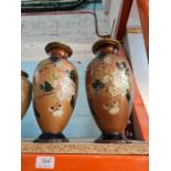 A pair of Doulton Lambeth vases having floral decoration and three other Royal Doulton stoneware va