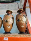 A pair of Doulton Lambeth vases having floral decoration and three other Royal Doulton stoneware va