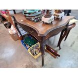 An early 20th Century mahogany side table with serpentine shaped top and one long drawer