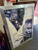 A signed movie poster for Alien v Predator with multiple signatures, two other posters and an illumi