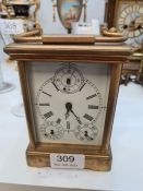 A French brass carriage clock having porcelain sides decorated maidens, multi dialled, 13.5cm