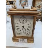 A French brass carriage clock having porcelain sides decorated maidens, multi dialled, 13.5cm