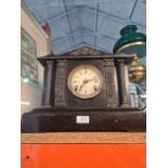 A Victorian style black painted mantle clock and a pencil signed etching by Brenda Hastill