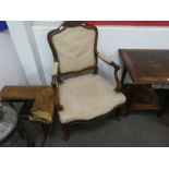 A pair of antique French Walnut open armchairs having carved decoration