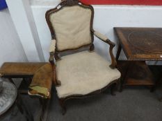 A pair of antique French Walnut open armchairs having carved decoration