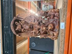 A carved Oriental wooden figure Thailand/Balinese depicting deities with dragons