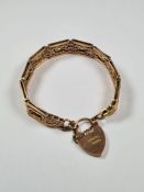 Antique 9ct Rose gold fancy gatelink bracelet comprising 9 panels with decorative centres, heart sha