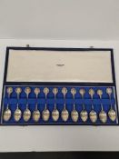 A cased set of twelve silver teaspoons having various figure medal style terminals. Hallmarked Londo