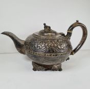 A highly decorative George III silver teapot having the whole body and spout embossed with flowers,